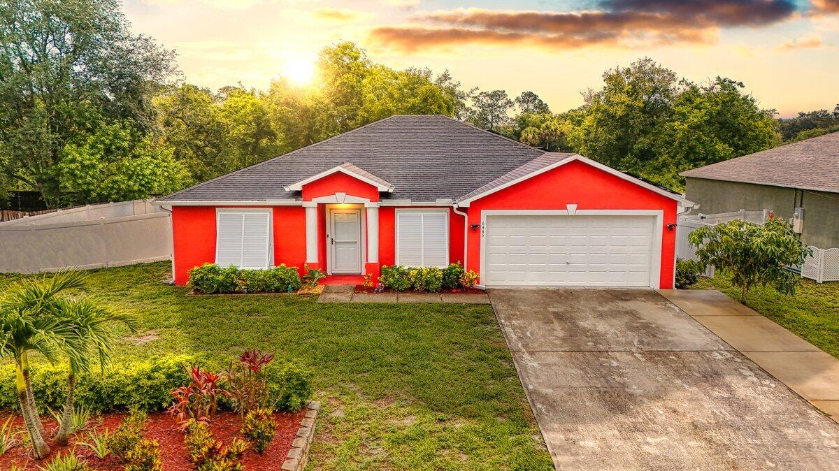 6445 Ainsworth Road Cocoa, FL 32927 - Photo 1 of 31 a front view of a house with a yard and garage