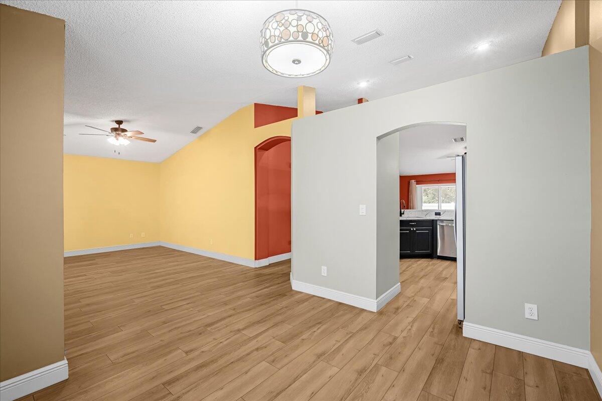 6445 Ainsworth Road Cocoa, FL 32927 - Photo 11 of 31 a view of a hallway with wooden floor