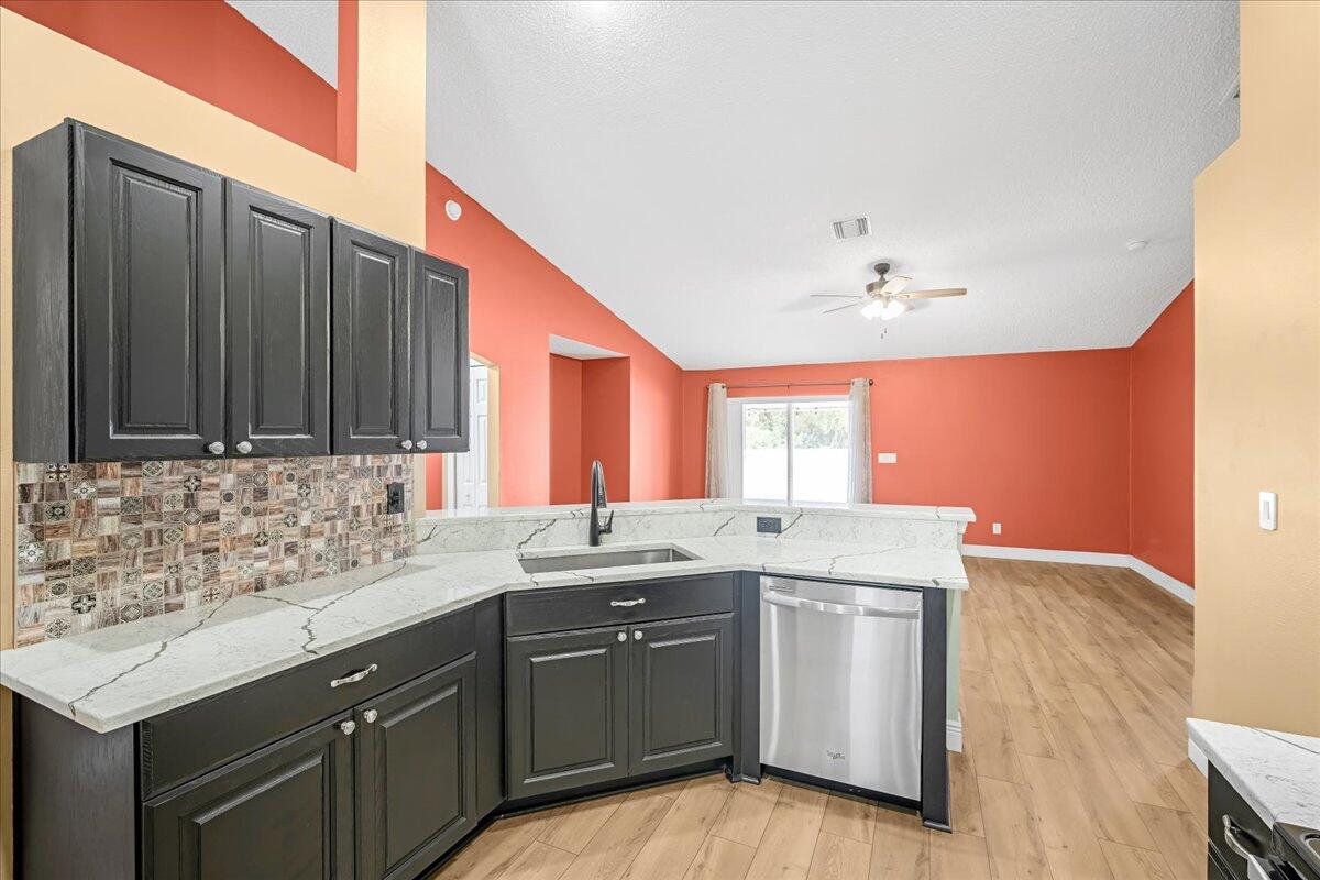 6445 Ainsworth Road Cocoa, FL 32927 - Photo 14 of 31 a kitchen with a sink cabinets and window