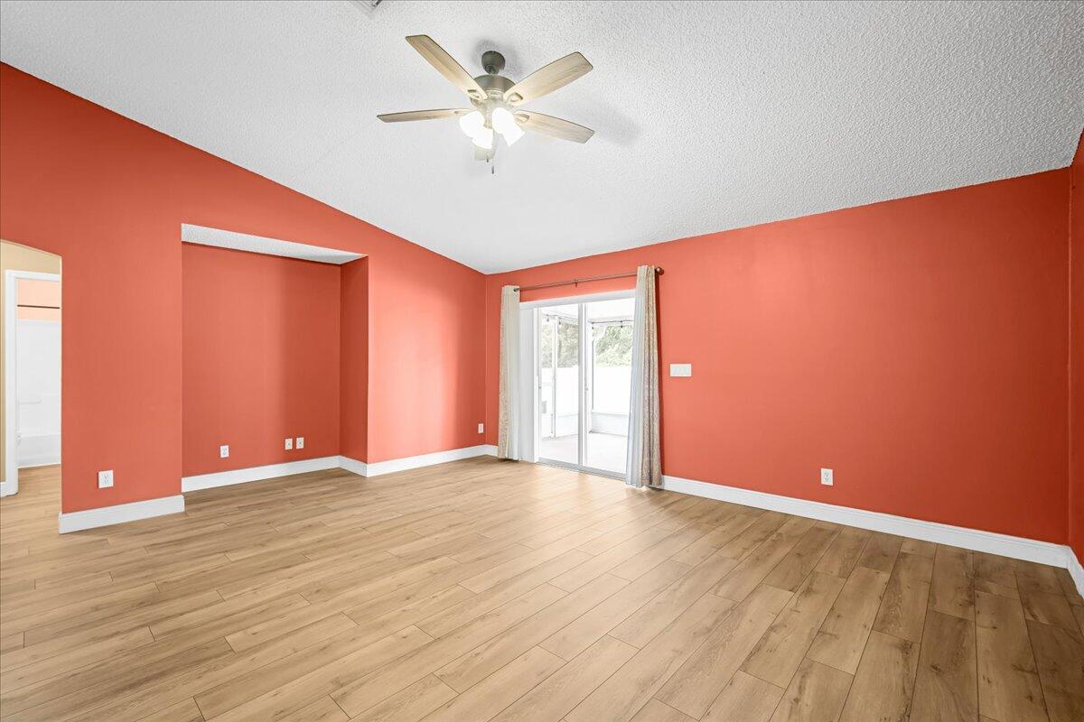 6445 Ainsworth Road Cocoa, FL 32927 - Photo 19 of 31 a view of an empty room with window and a ceiling fan