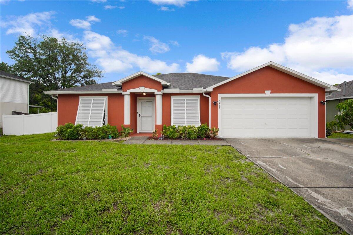 6445 Ainsworth Road Cocoa, FL 32927 - Photo 2 of 31 a front view of house with yard and green space
