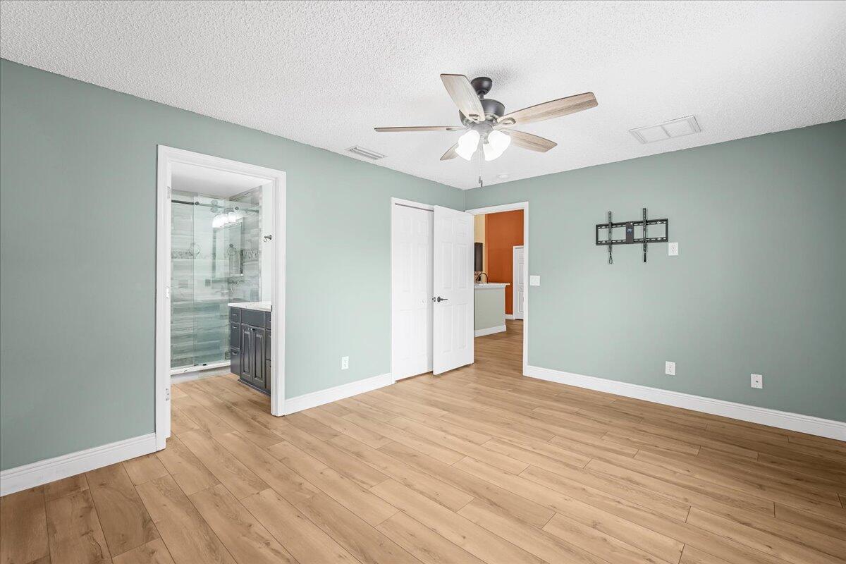 6445 Ainsworth Road Cocoa, FL 32927 - Photo 21 of 31 a view of an empty room with wooden floor