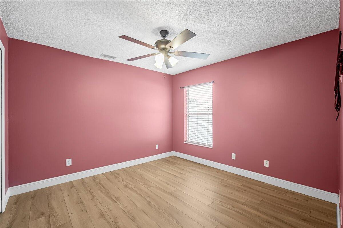 6445 Ainsworth Road Cocoa, FL 32927 - Photo 24 of 31 an empty room with window and ceiling fan