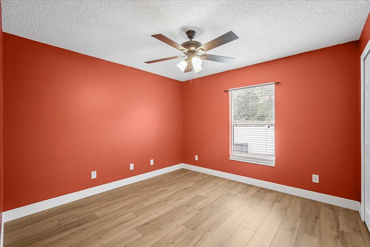 6445 Ainsworth Road Cocoa, FL 32927 - Photo 26 of 31 an empty room with a window and ceiling fan