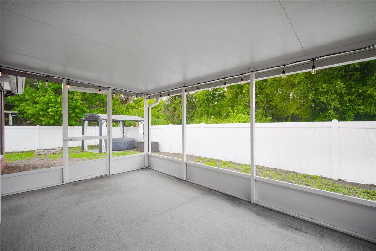 6445 Ainsworth Road Cocoa, FL 32927 - Photo 28 of 31 a view of an empty room with a floor to ceiling window and an outdoor view
