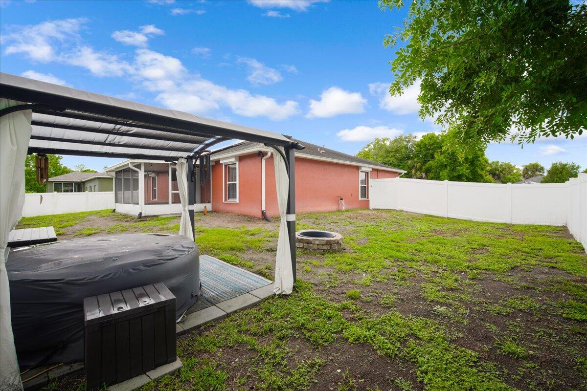 6445 Ainsworth Road Cocoa, FL 32927 - Photo 30 of 31 a backyard of a house with seating space