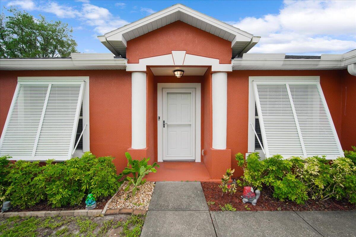 6445 Ainsworth Road Cocoa, FL 32927 - Photo 5 of 31 a front view of a house with garden