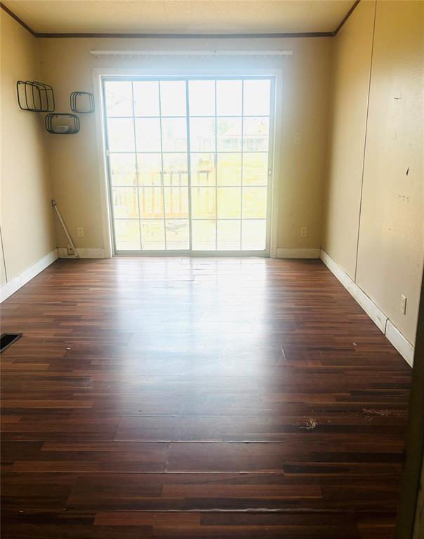 1100 Pecan Ridge Drive Venus, TX 76084 - Photo 12 of 13 Spare room with healthy amount of natural light and dark wood-style floors