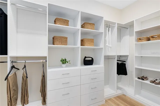 a bedroom with a bed and cabinets