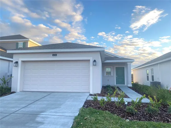 a front view of house with yard garage and garage
