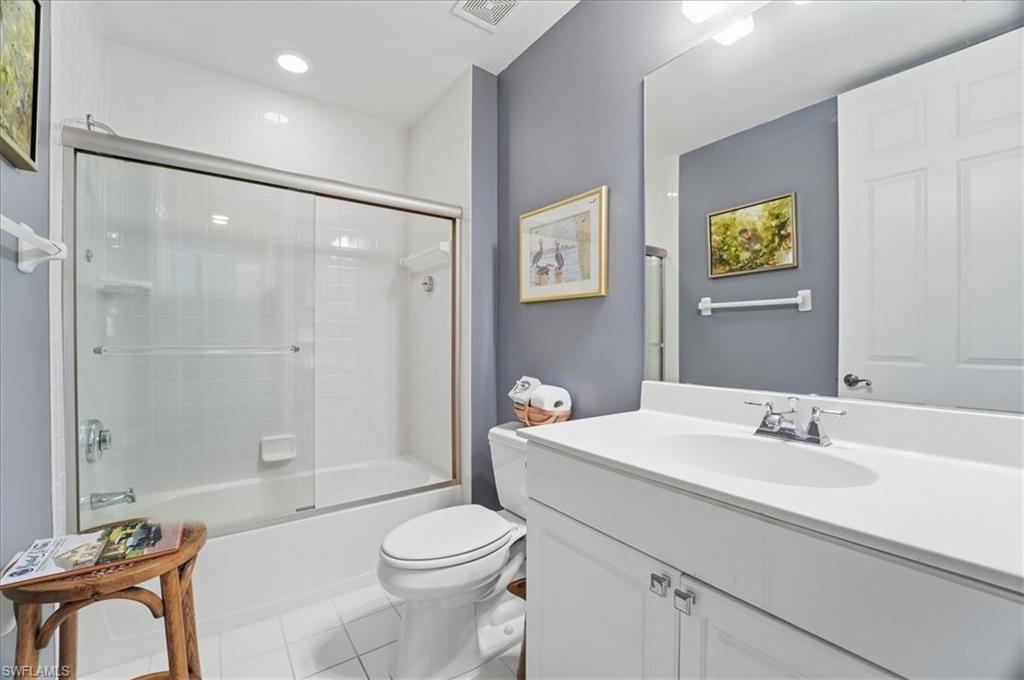 1109 Egrets Walk Circle, Unit 104 Naples, FL 34108 - Photo 12 of 17 a bathroom with a sink toilet and shower