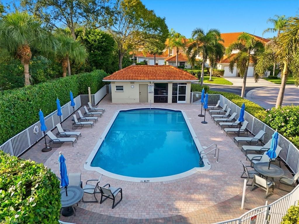 1109 Egrets Walk Circle, Unit 104 Naples, FL 34108 - Photo 15 of 17 a view of a swimming pool with a patio