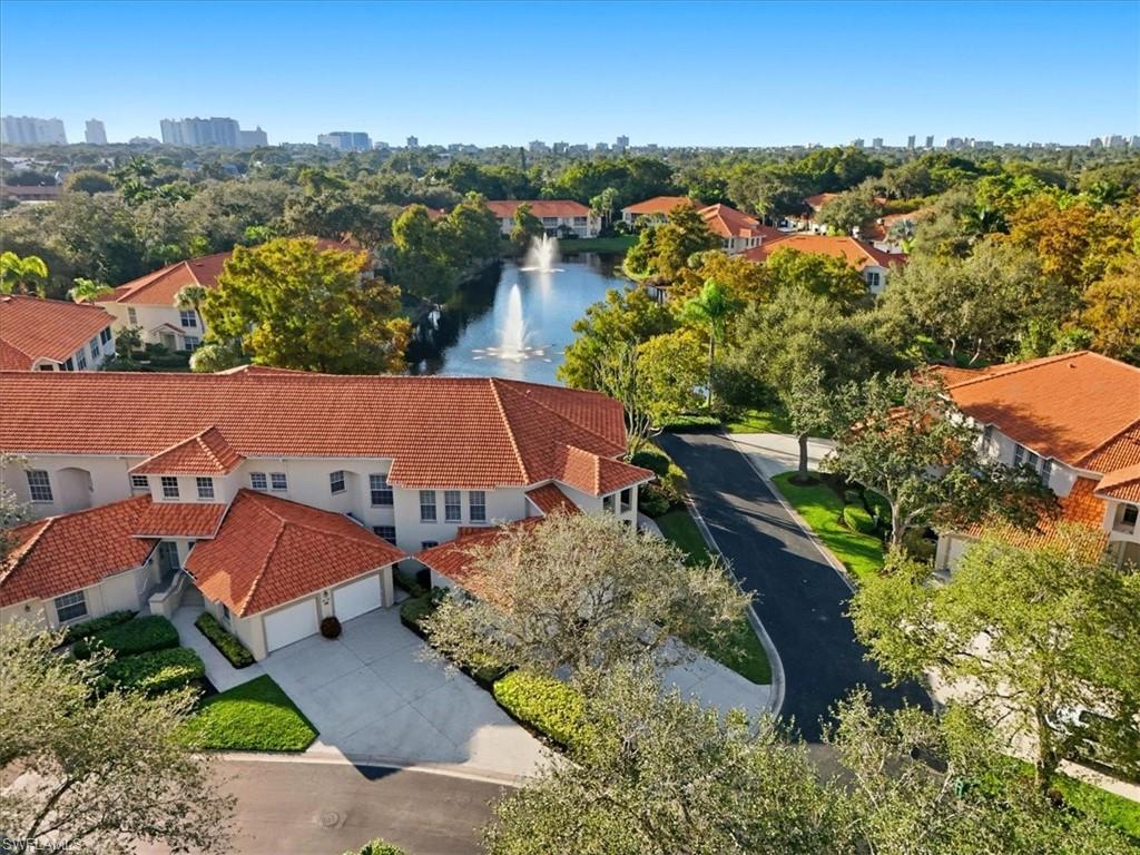 1109 Egrets Walk Circle, Unit 104 Naples, FL 34108 - Photo 16 of 17 an aerial view of residential houses with outdoor space and trees
