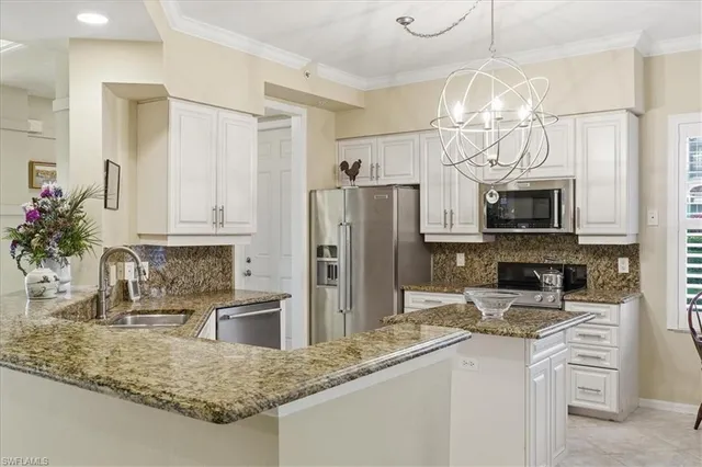 a kitchen with stainless steel appliances granite countertop a sink refrigerator stove and microwave