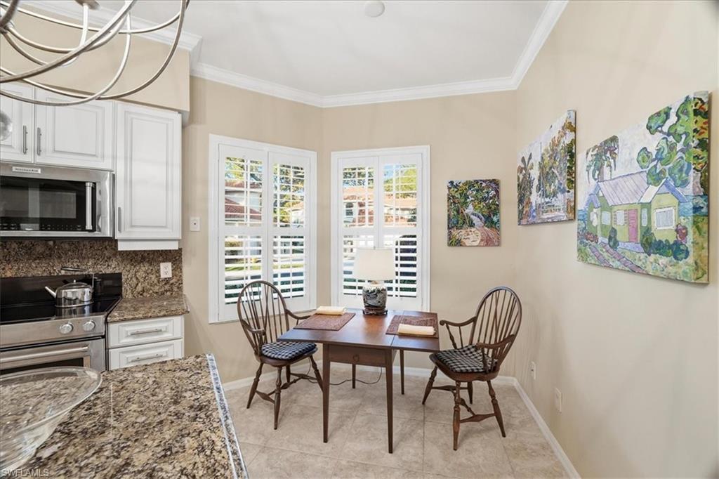 1109 Egrets Walk Circle, Unit 104 Naples, FL 34108 - Photo 7 of 17 a view of a livingroom with furniture a flat screen tv and a window