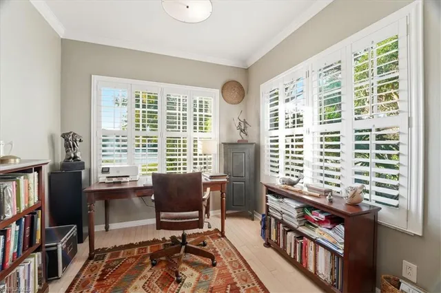 a view of a workspace with furniture and a bookshelf