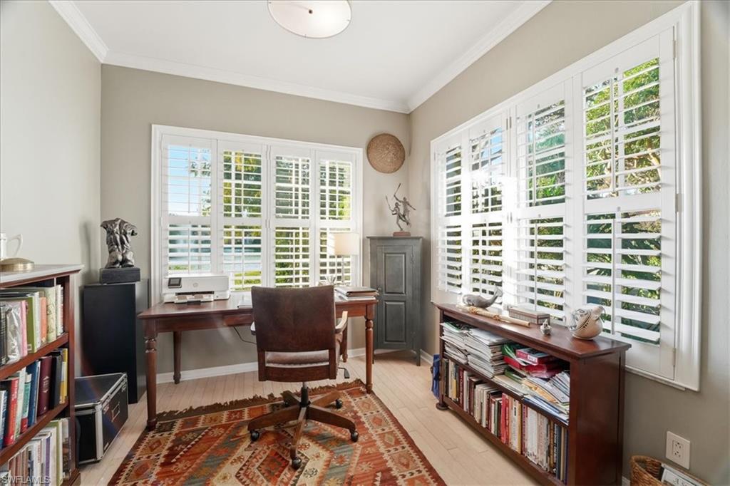 1109 Egrets Walk Circle, Unit 104 Naples, FL 34108 - Photo 8 of 17 a view of a workspace with furniture and a bookshelf