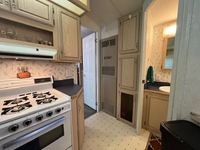 2795 East 28th Road Marseilles, IL 61341 - Photo 15 of 58 a kitchen with stainless steel appliances a stove a refrigerator and cabinets