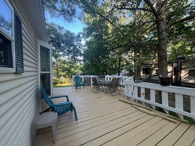 2795 East 28th Road Marseilles, IL 61341 - Photo 4 of 58 a view of a patio with table and chairs and wooden floor
