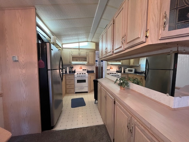 2795 East 28th Road Marseilles, IL 61341 - Photo 10 of 58 a kitchen with stainless steel appliances kitchen island granite countertop a refrigerator and a stove top oven