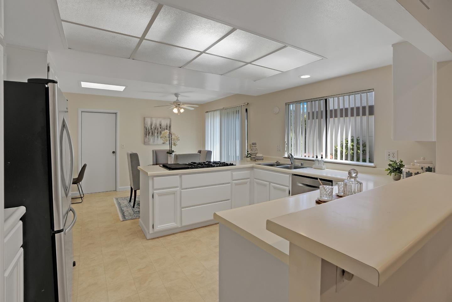 6294 Blauer Lane San Jose, CA 95135 - Photo 13 of 26 a large white kitchen with a sink and stainless steel appliances