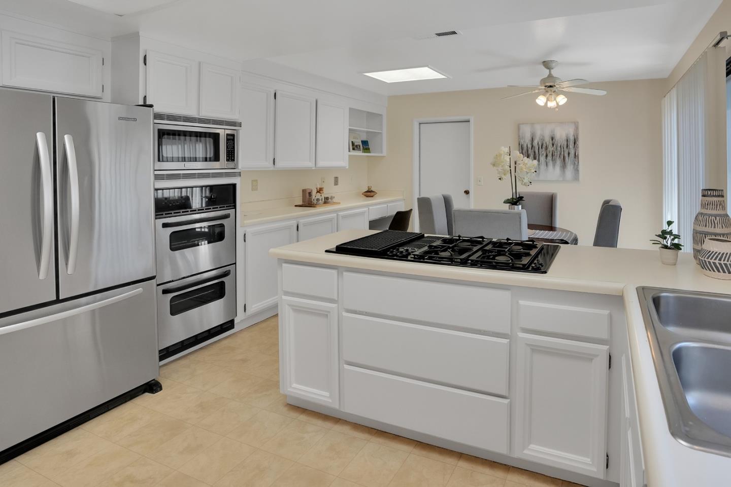 6294 Blauer Lane San Jose, CA 95135 - Photo 15 of 26 a kitchen with stainless steel appliances white cabinets and a refrigerator