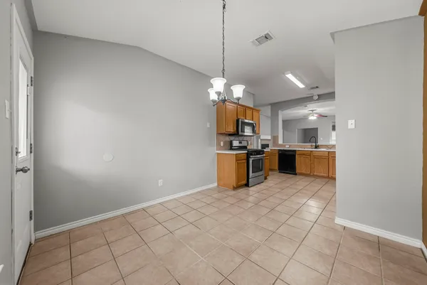 a open kitchen with cabinets and stainless steel appliances