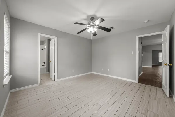 a view of empty room with wooden floor