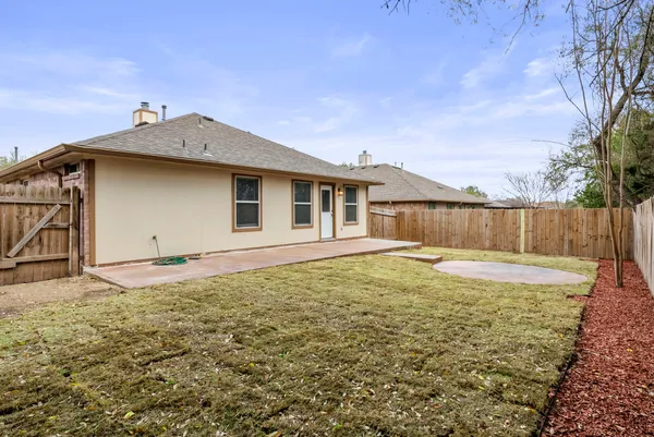 a view of a house with yard and sitting area