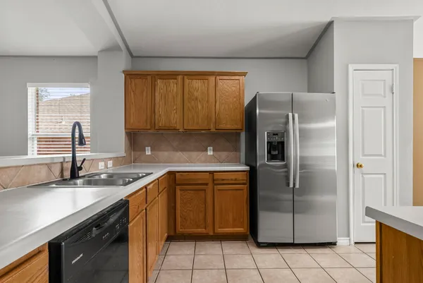 a kitchen with stainless steel appliances granite countertop a refrigerator sink and cabinets