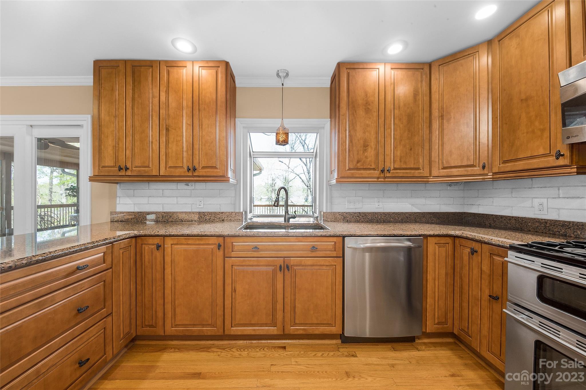 10700 Fairway Ridge Road Charlotte, NC 28277 - Photo 13 of 39 a kitchen with stainless steel appliances granite countertop a sink stove and cabinets