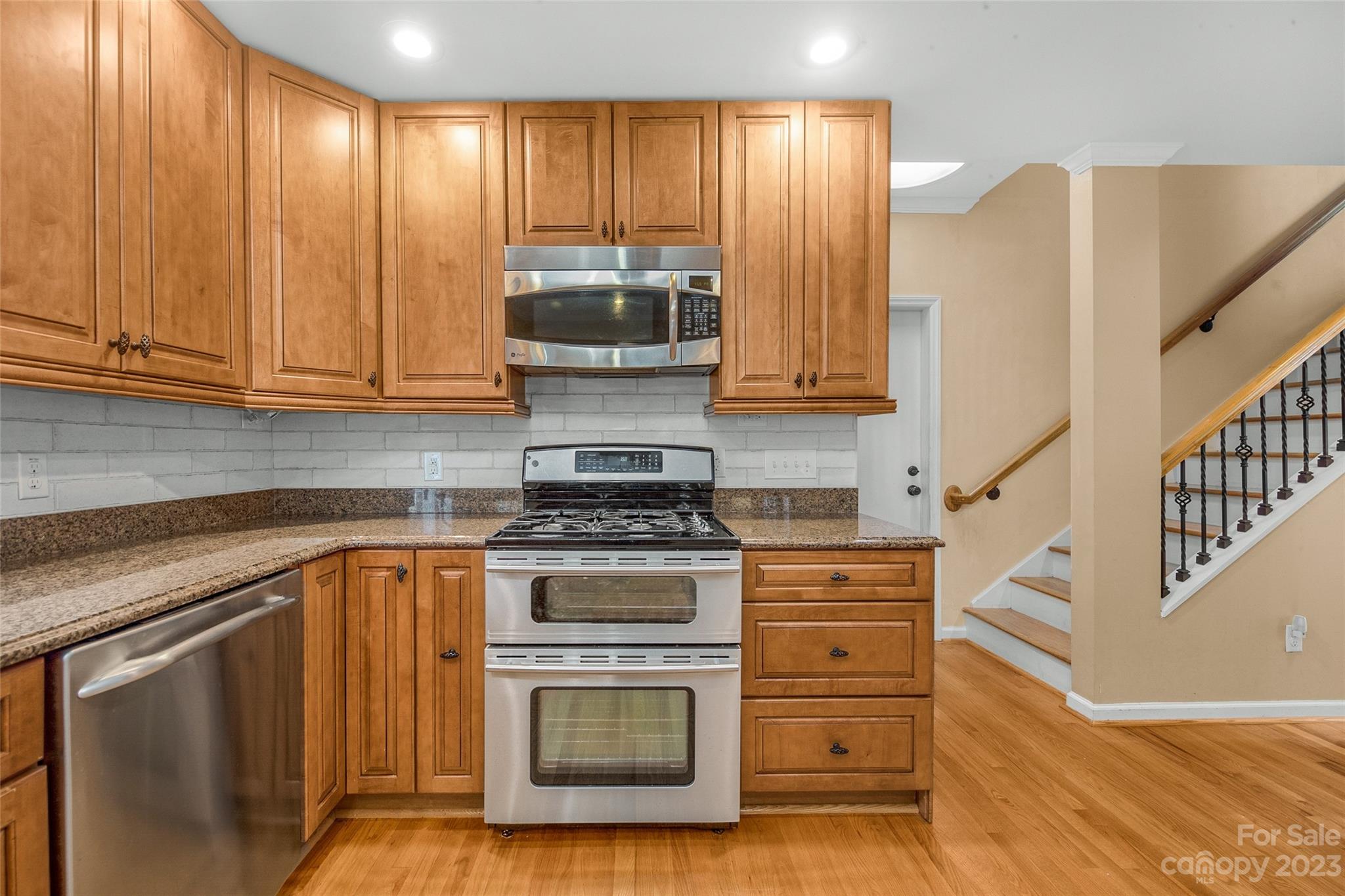 10700 Fairway Ridge Road Charlotte, NC 28277 - Photo 16 of 39 a kitchen with wooden cabinets and a stove top oven