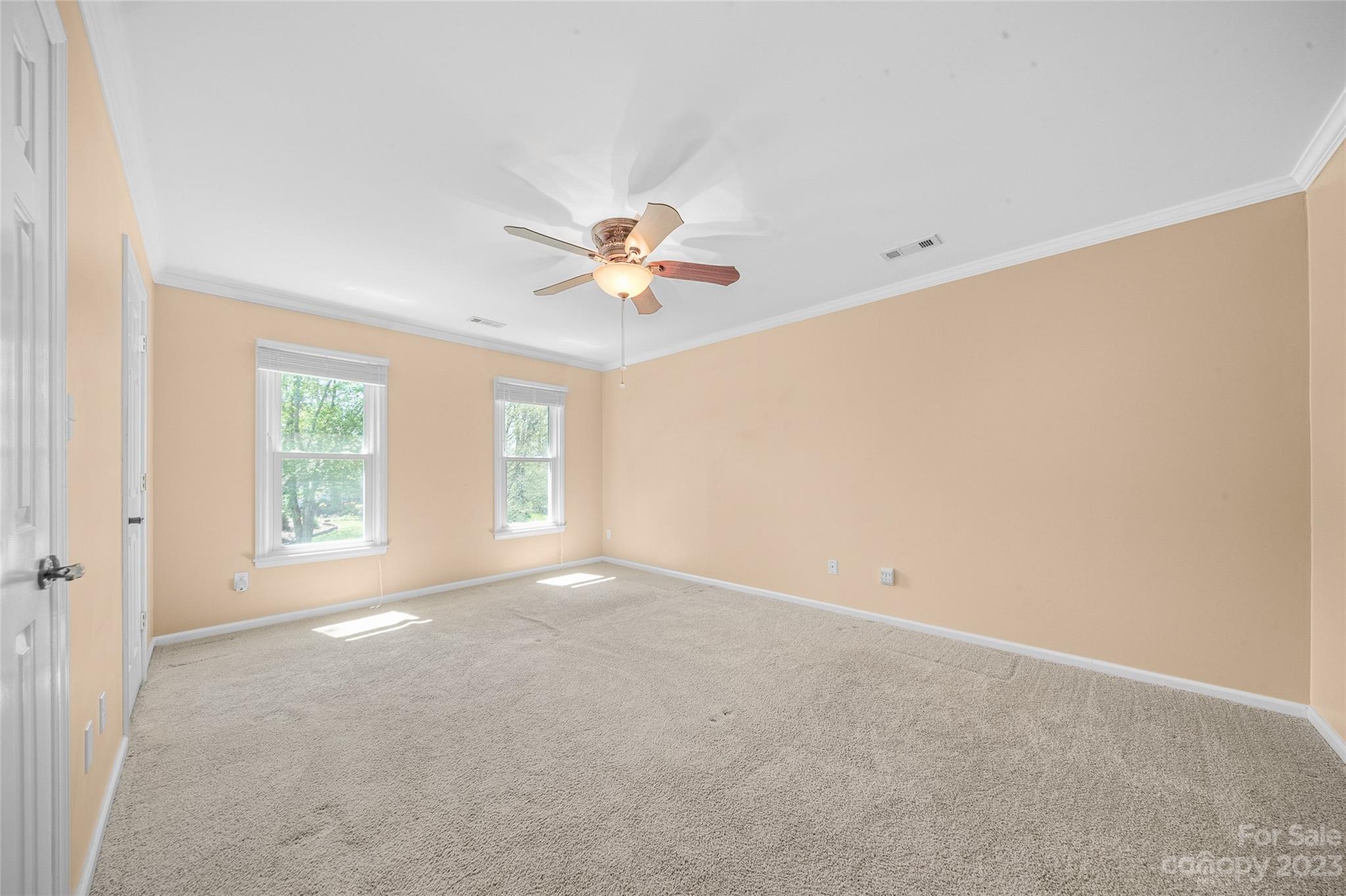 10700 Fairway Ridge Road Charlotte, NC 28277 - Photo 26 of 39 an empty room with windows and chandelier fan