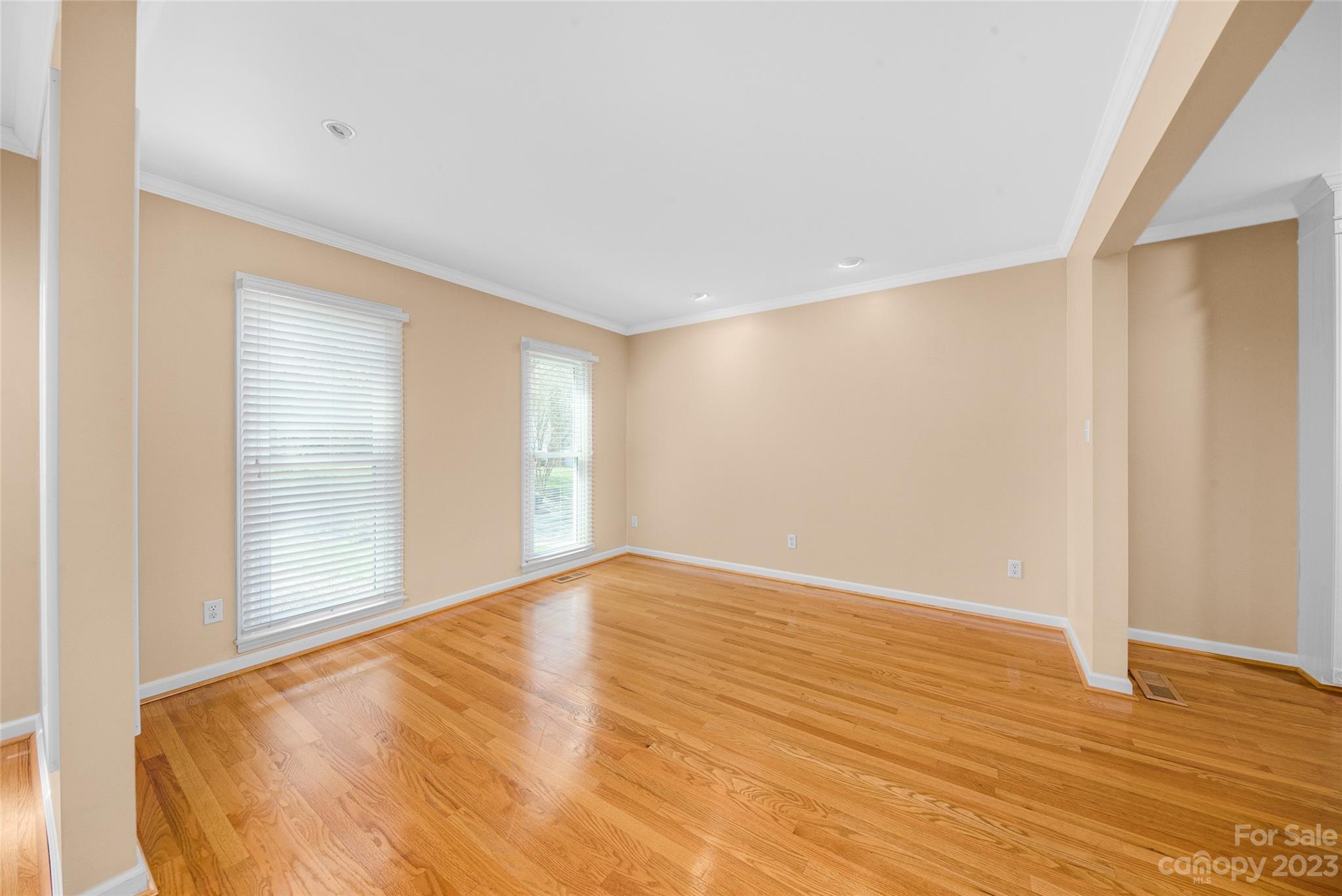 10700 Fairway Ridge Road Charlotte, NC 28277 - Photo 8 of 39 a view of an empty room with wooden floor and a window