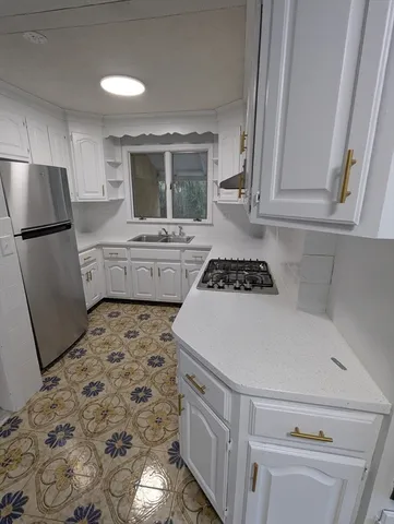 a kitchen with a refrigerator and a stove