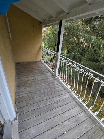 a balcony with wooden floor in outdoor space