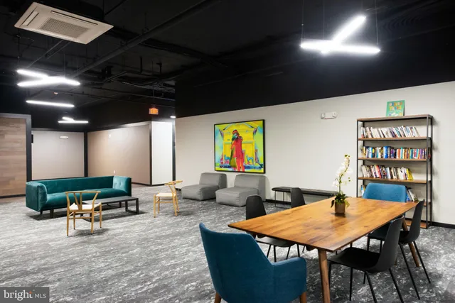 a living room with furniture a rug and a chandelier