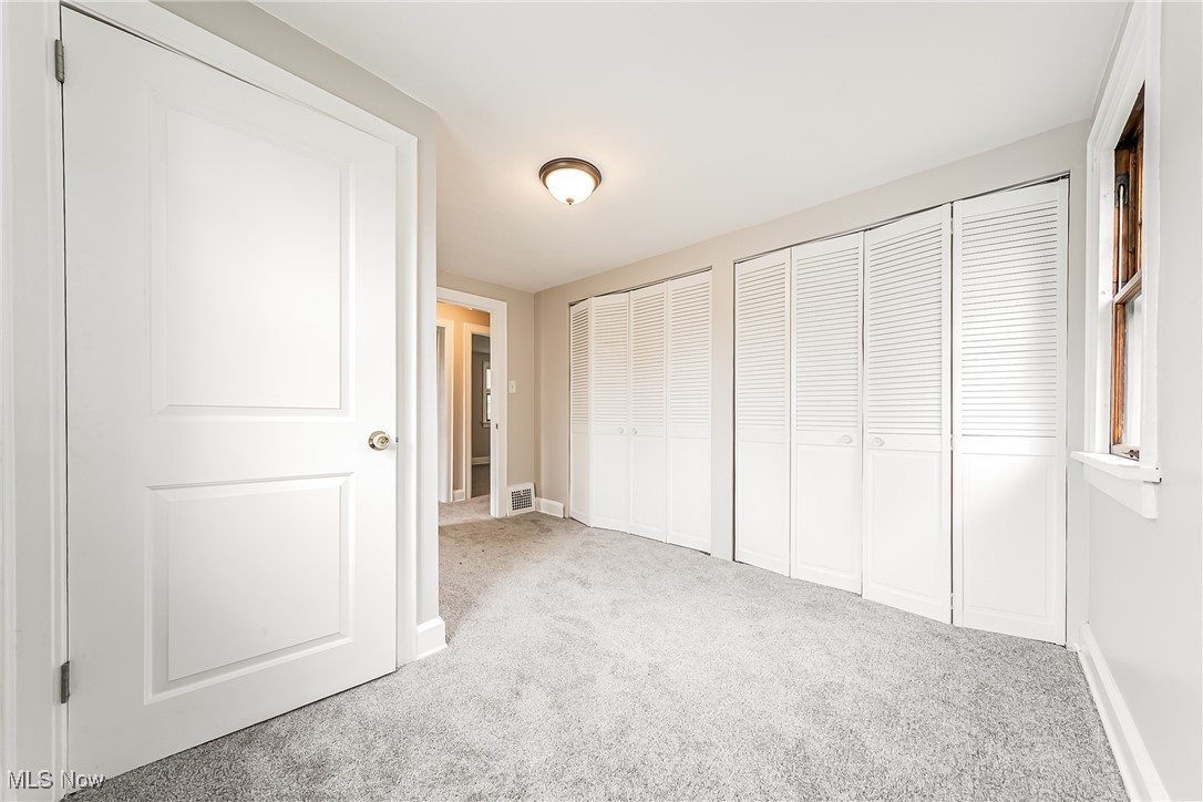 1271 Winston Road Cleveland, OH 44121 - Photo 22 of 43 Unfurnished bedroom featuring carpet and two closets