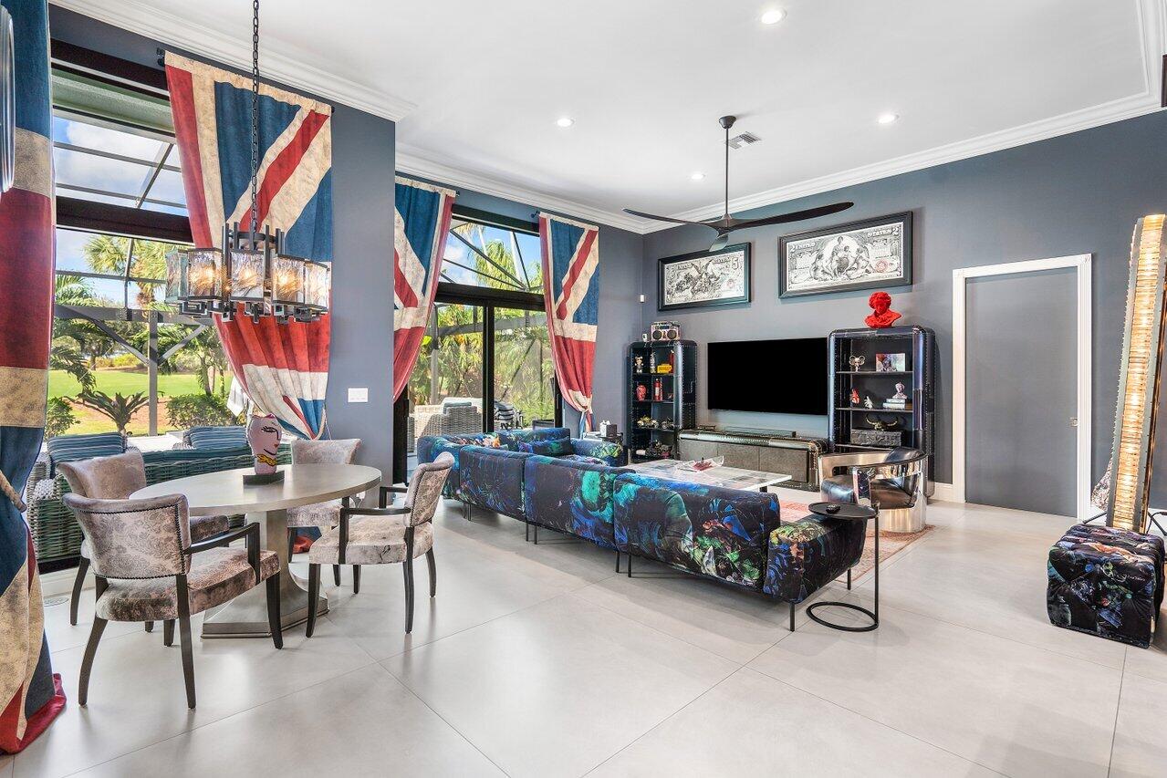 4848 Chamal Circle Boca Raton, FL 33487 - Photo 11 of 88 a living room with furniture a flat screen tv and a large window