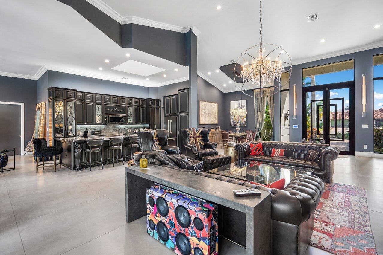4848 Chamal Circle Boca Raton, FL 33487 - Photo 16 of 88 a very nice looking living room with stainless steel appliances furniture and a chandelier