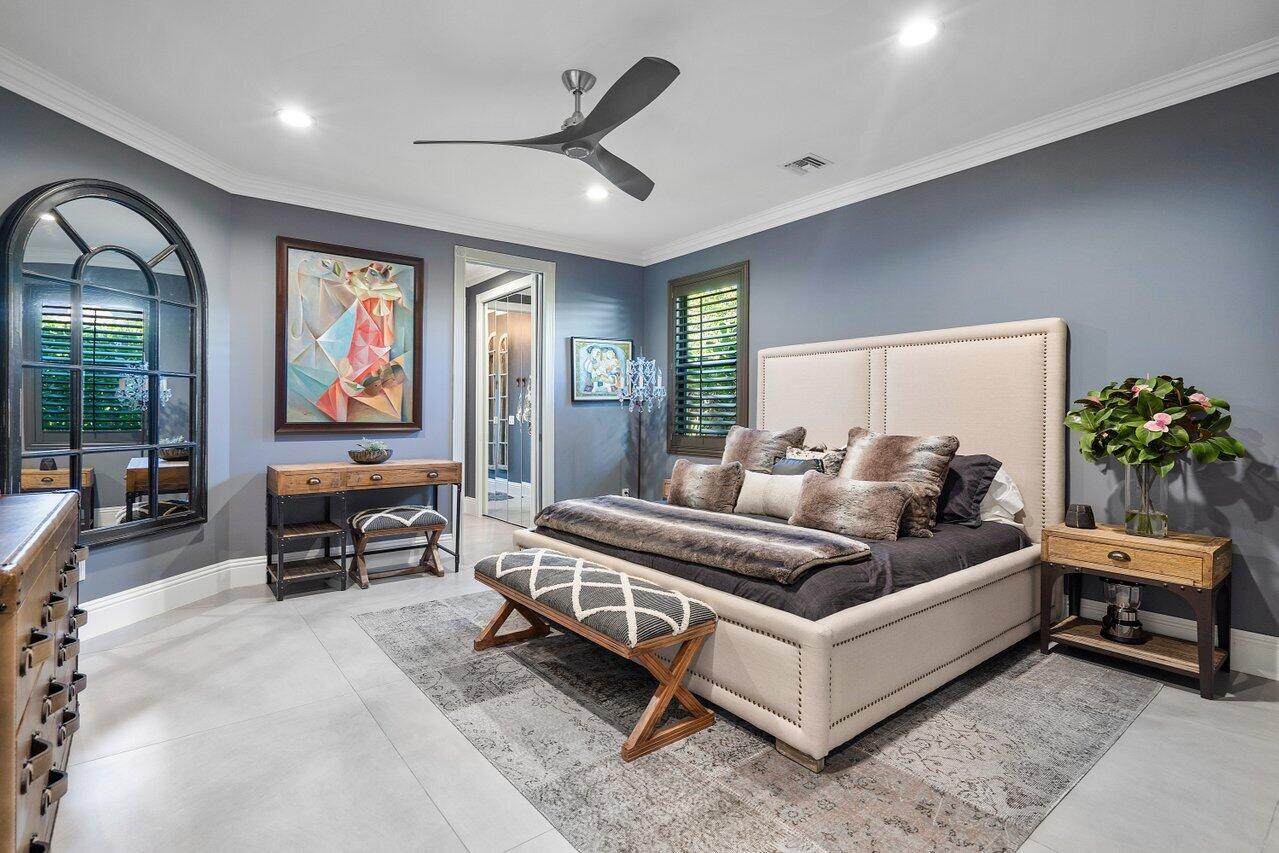 4848 Chamal Circle Boca Raton, FL 33487 - Photo 23 of 88 a spacious bedroom with a bed a couch and large windows