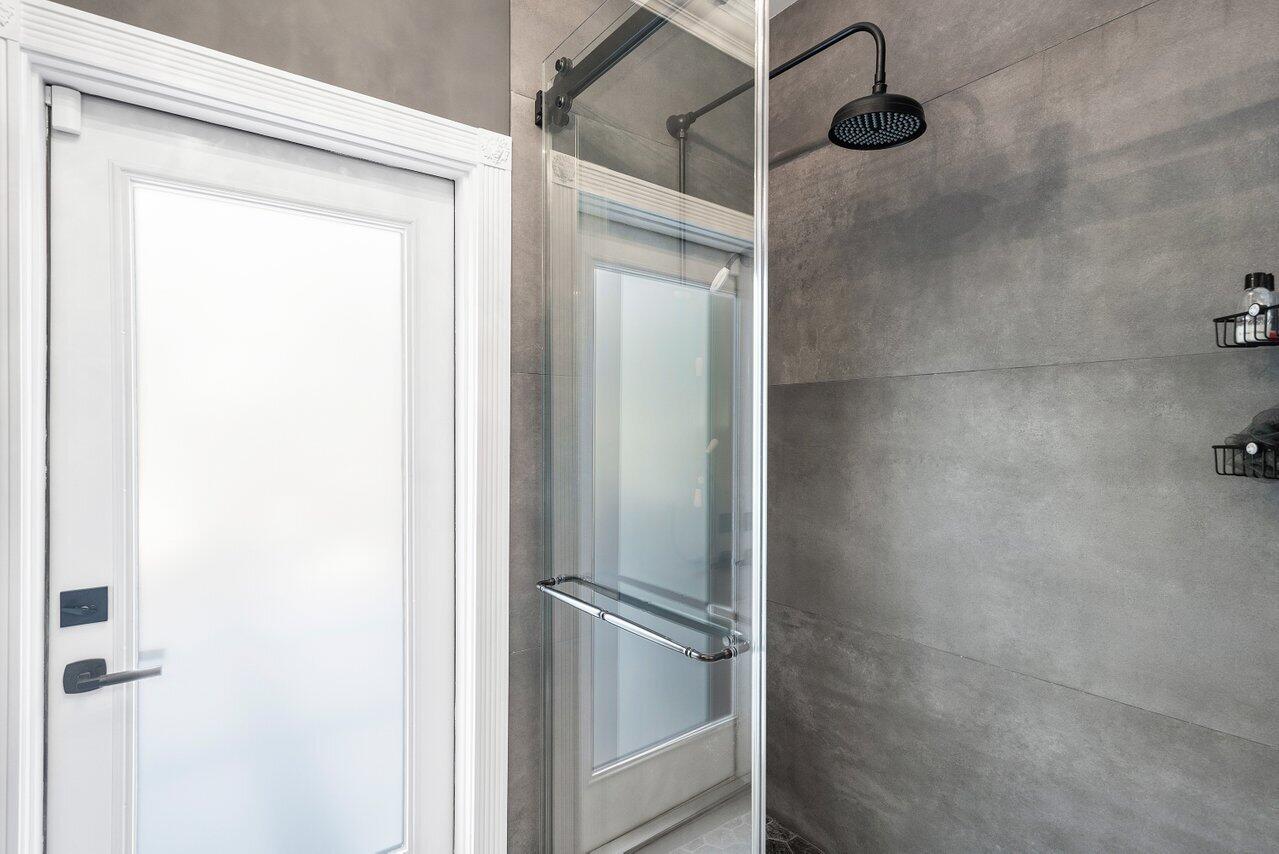 4848 Chamal Circle Boca Raton, FL 33487 - Photo 27 of 88 a bathroom with a glass shower door
