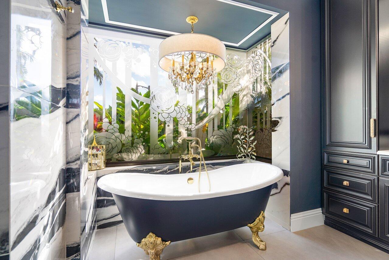 4848 Chamal Circle Boca Raton, FL 33487 - Photo 31 of 88 a bathroom with a bathtub and a shower