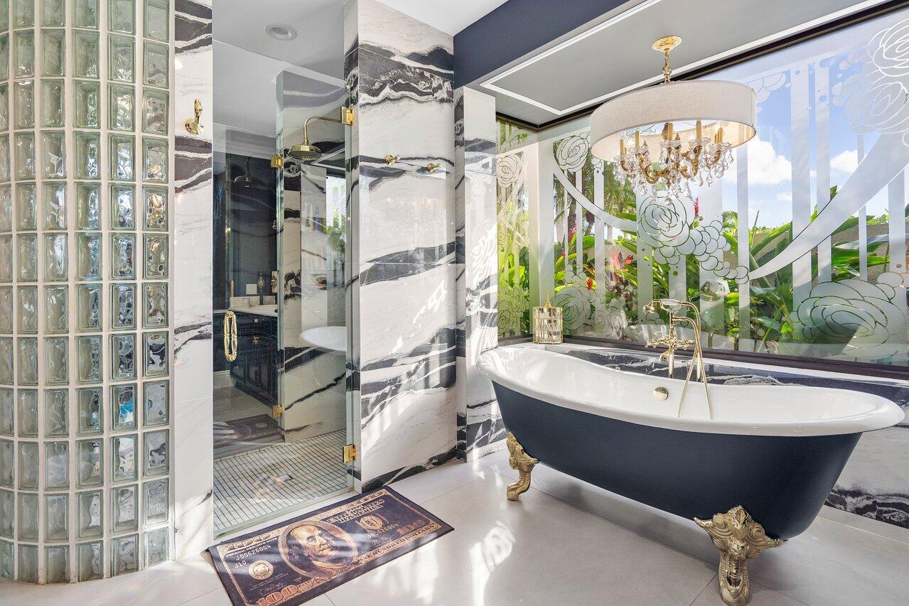 4848 Chamal Circle Boca Raton, FL 33487 - Photo 33 of 88 a bathroom with a bathtub and shower