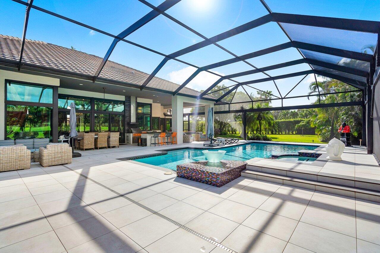 4848 Chamal Circle Boca Raton, FL 33487 - Photo 41 of 88 a living room with patio furniture and a floor to ceiling window