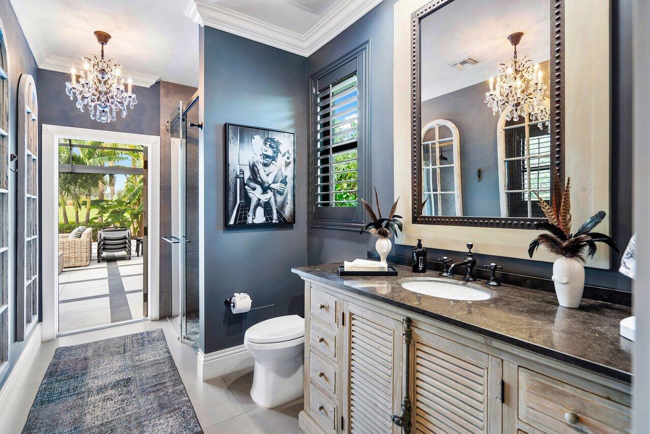 4848 Chamal Circle Boca Raton, FL 33487 - Photo 44 of 88 a bathroom with a double vanity sink and a mirror