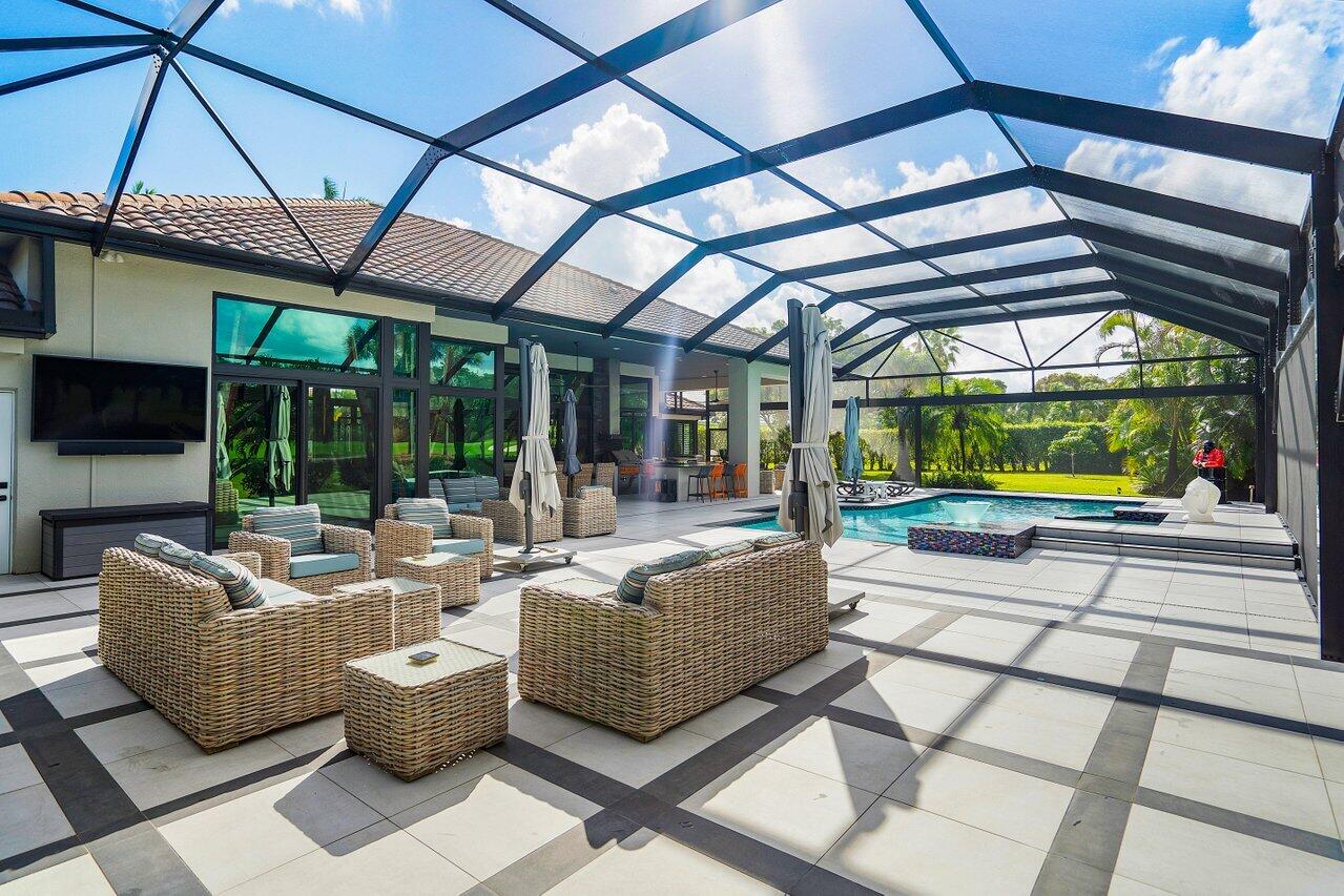 4848 Chamal Circle Boca Raton, FL 33487 - Photo 45 of 88 a living room with patio furniture and a floor to ceiling window