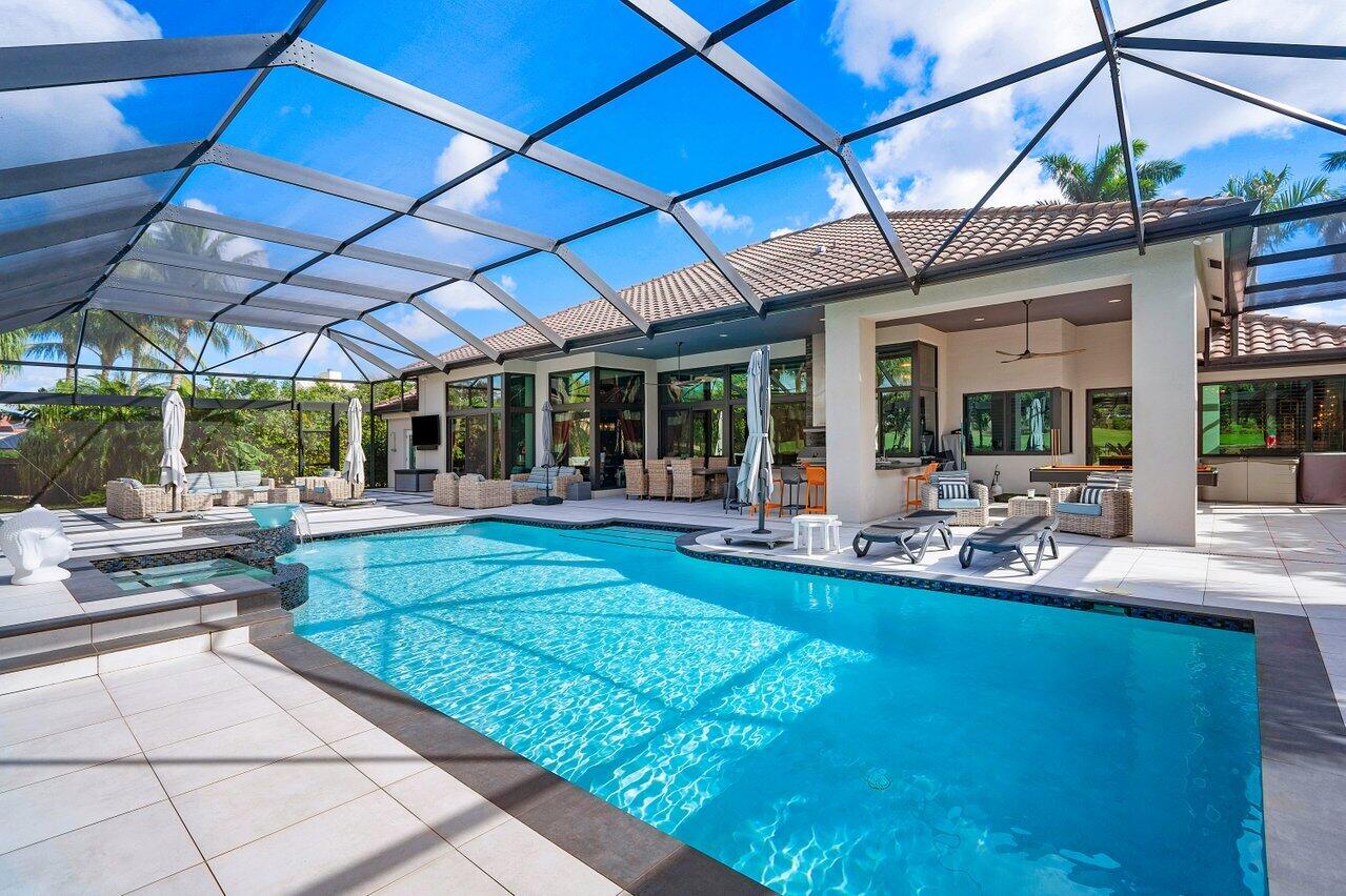 4848 Chamal Circle Boca Raton, FL 33487 - Photo 46 of 88 a view of a backyard with table and chairs under an umbrella