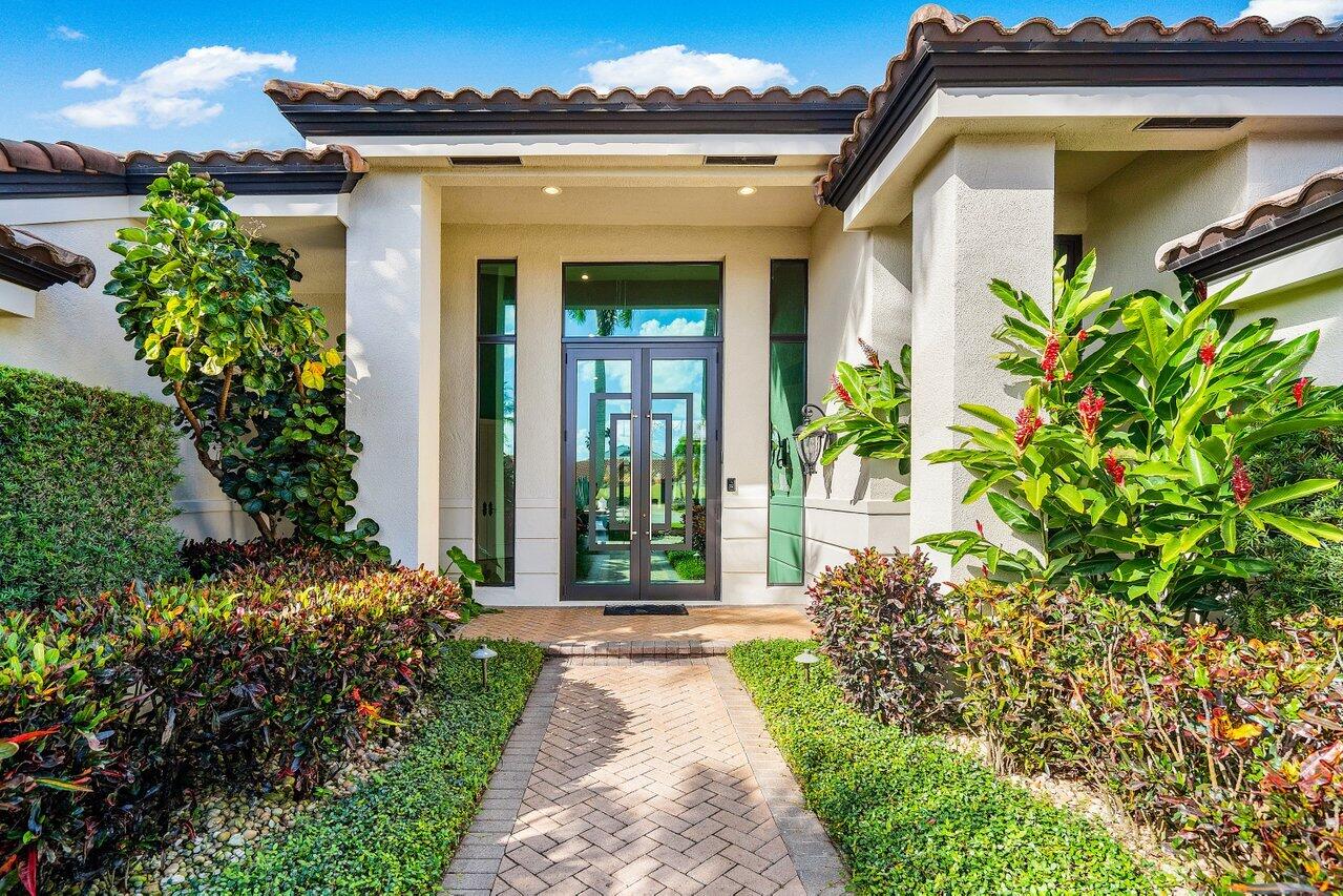 4848 Chamal Circle Boca Raton, FL 33487 - Photo 6 of 88 a front view of a house with garden