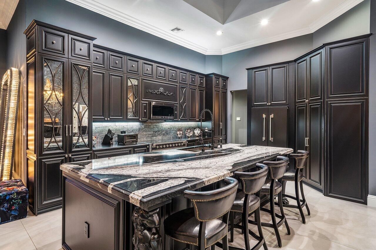 4848 Chamal Circle Boca Raton, FL 33487 - Photo 64 of 88 a kitchen with stainless steel appliances granite countertop a stove a refrigerator and a microwave